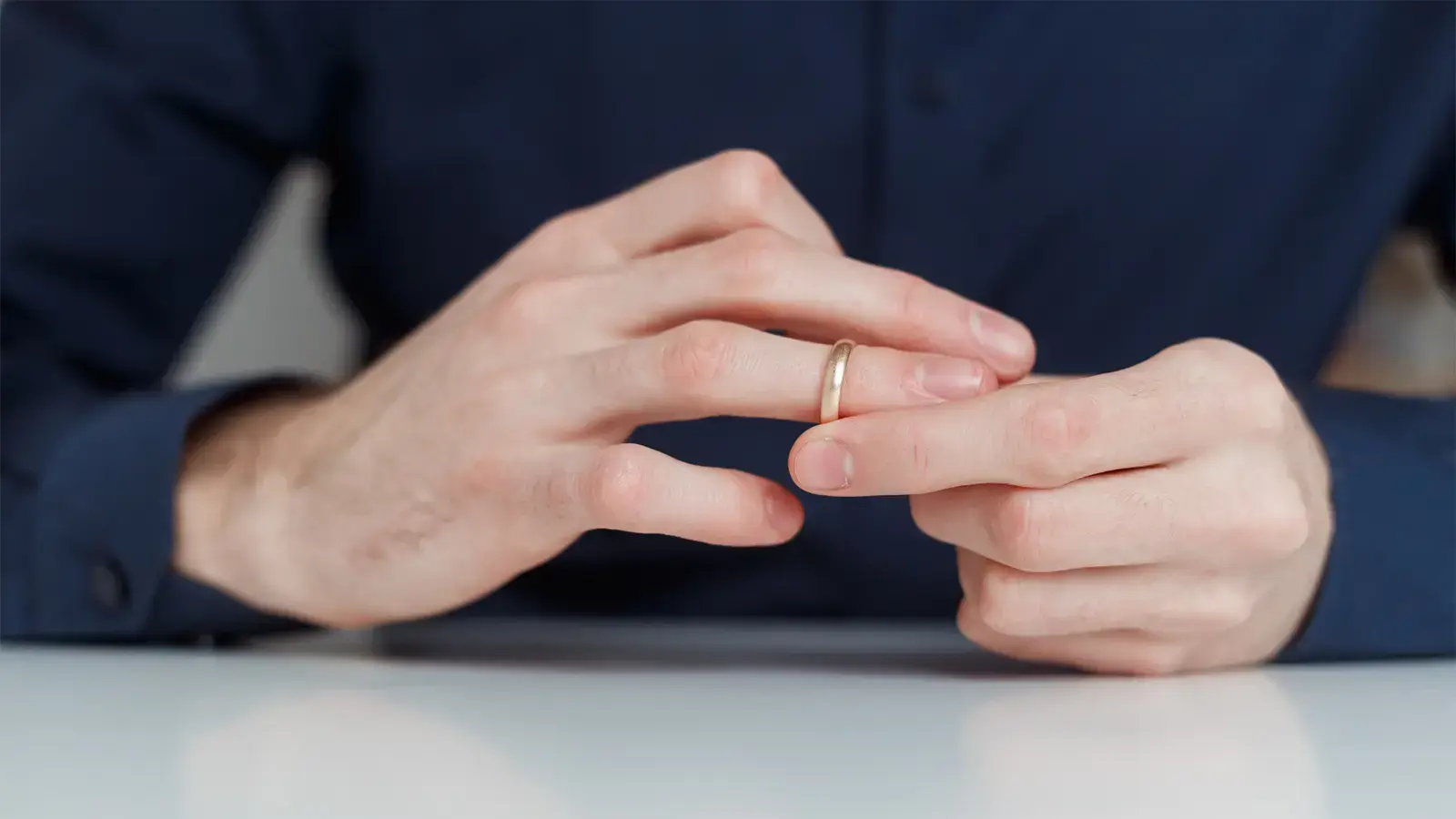 Divorcio. Persona quitándose su anillo de compromiso