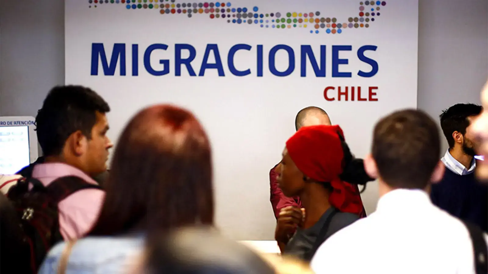 Regularización migratoria. Personas en una oficina