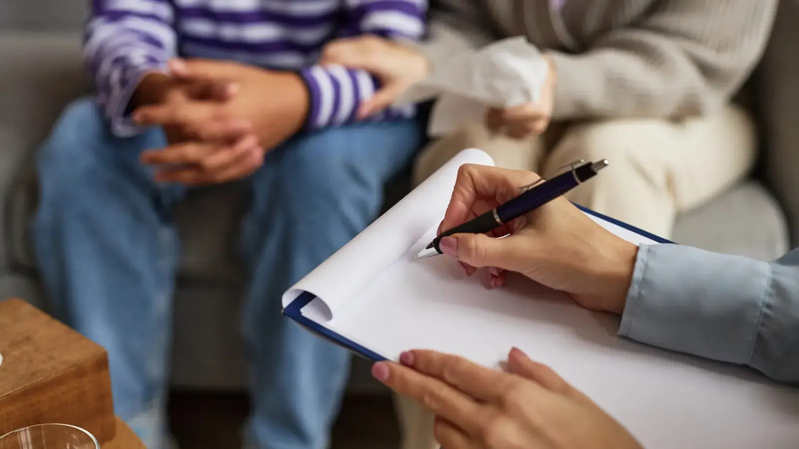 Violencia intrafamiliar. Abogada firmando contrato frentre a mujeres